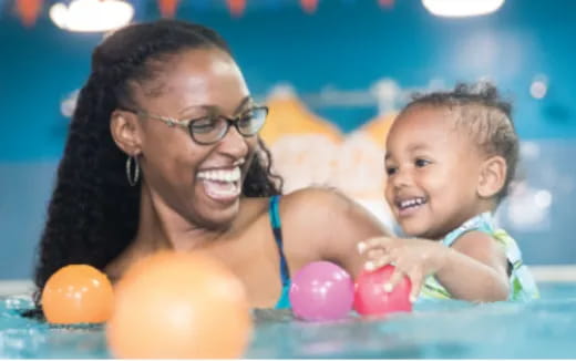 a person and a baby in a pool