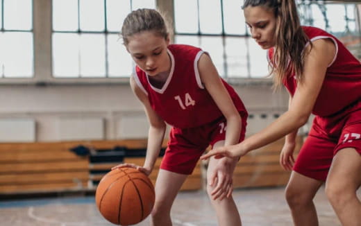a couple of girls playing basketball