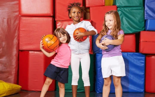 a group of kids holding a ball