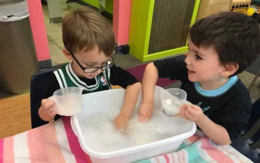 two boys sitting at a table