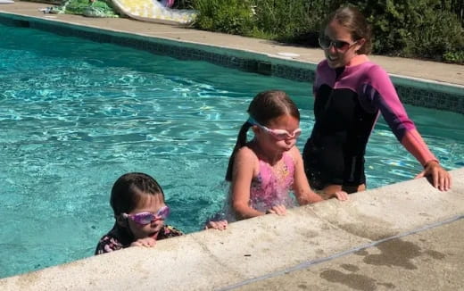 a man and two girls in a pool