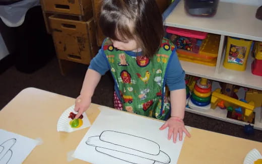 a child painting on a table
