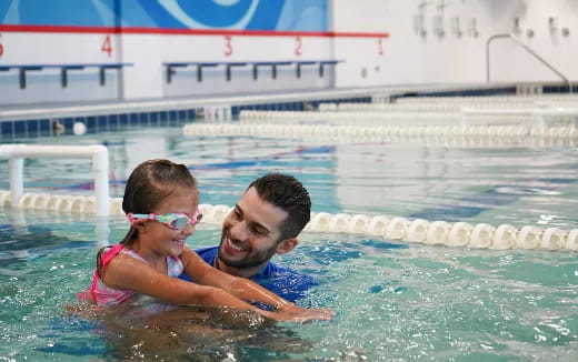 a man and a child in a pool