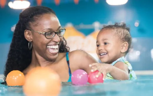 a person and a baby in a pool