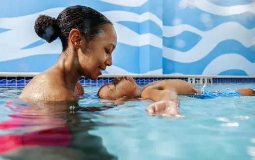 a person and a baby in a pool