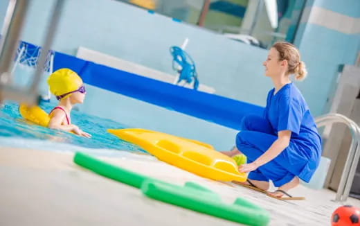 a person and a child playing in a pool