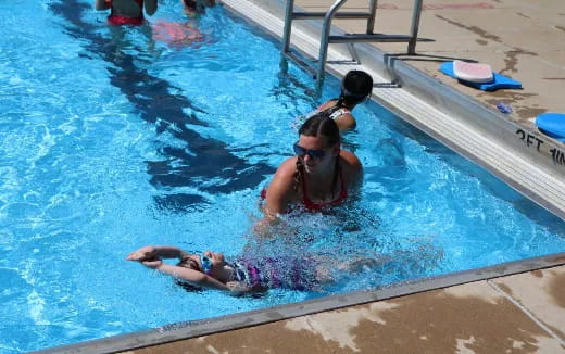 a person and a child in a pool