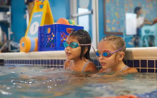 a couple of girls in a pool