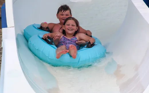 a boy and girl in a pool