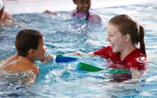 a group of children playing in the water
