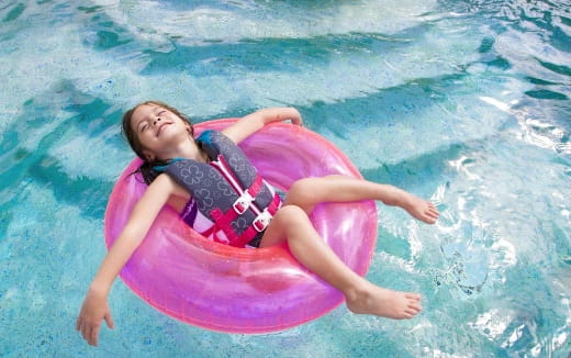 a person lying on a floating pool