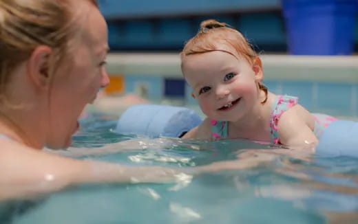 a woman and a child in a pool