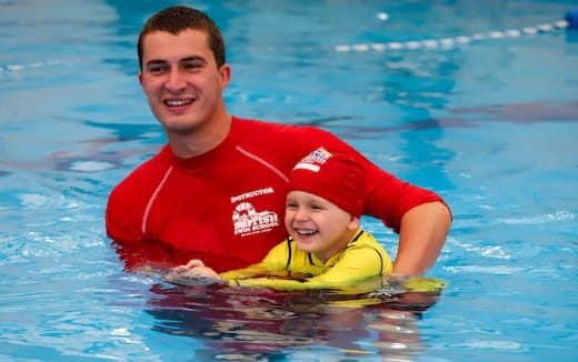 a person and a baby in a pool