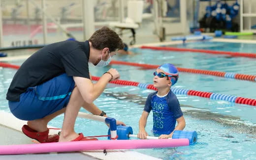 a man and a child in a pool