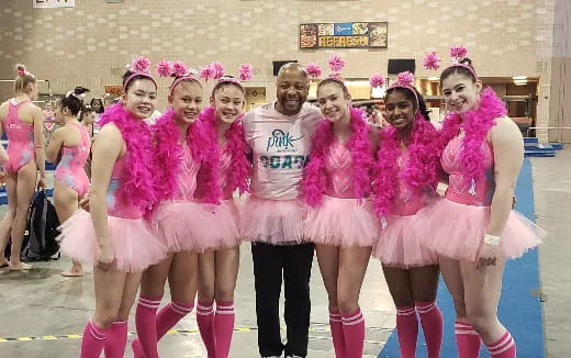 a group of women in pink and white dresses