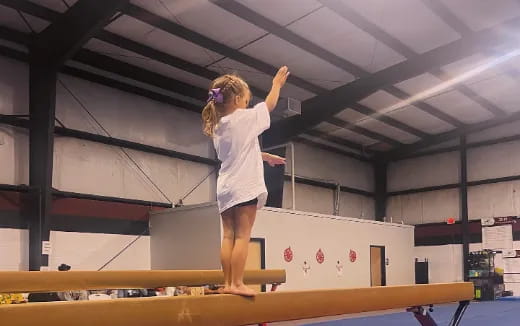 a woman standing on a beam