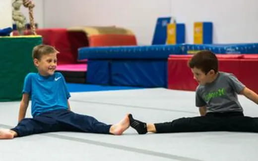 a couple of boys sitting on the floor