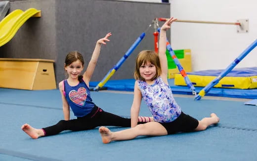 a couple of girls on a mat