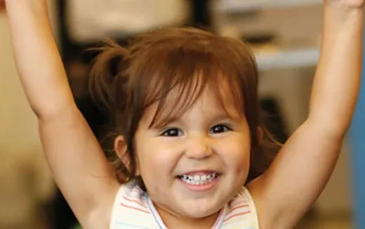 a child with her hands on her head