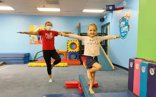 a couple of women exercising in a gym