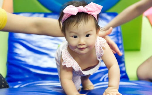 a baby girl wearing a pink bow