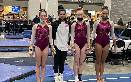a group of women in leotards posing for a photo