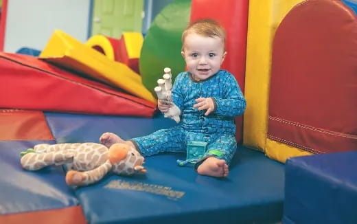 a baby sitting on a slide