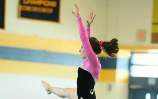 a woman doing a gymnastics move