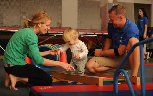 a man and woman and a child on a mat