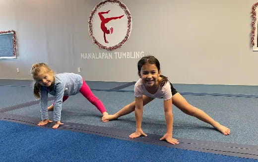 a couple of girls doing yoga