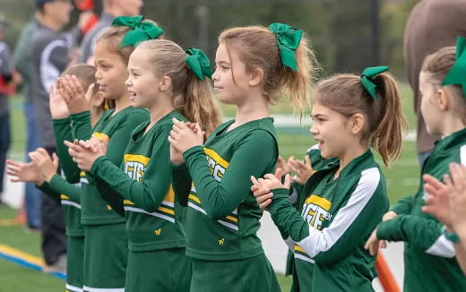 a group of girls in green uniforms