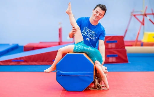 a person sitting on a blue mat