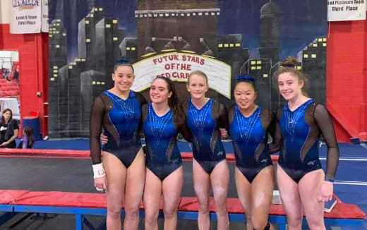 a group of women in swimsuits posing for a photo