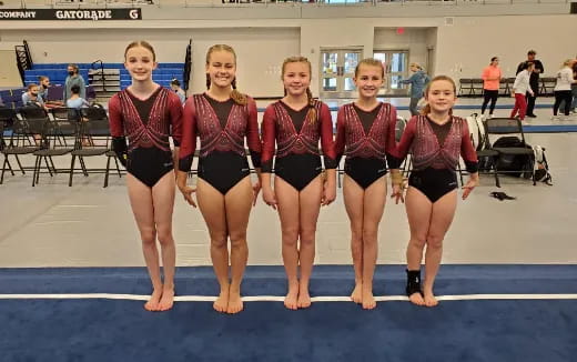 a group of women in leotards posing for a photo