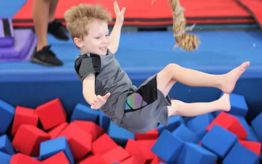 a boy on a red and blue slide