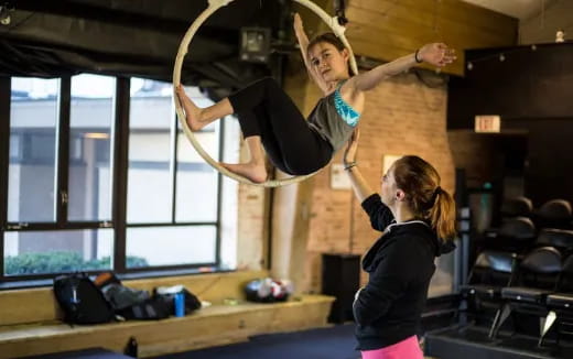 a person lifting another woman up