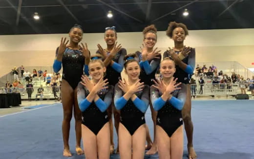 a group of women in leotards posing for a photo