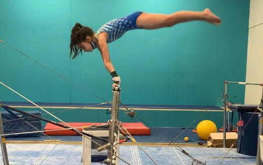 a person jumping over a bar