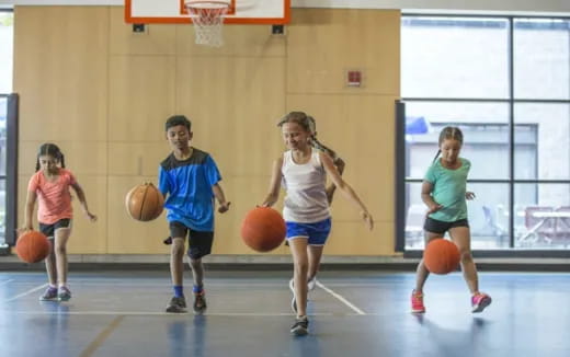 a group of kids playing basketball