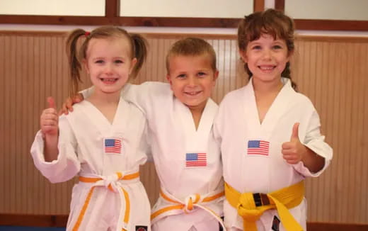 a group of children wearing matching outfits