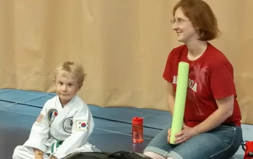 a person and a child sitting on a couch