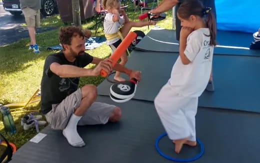 a person and a girl playing with a toy