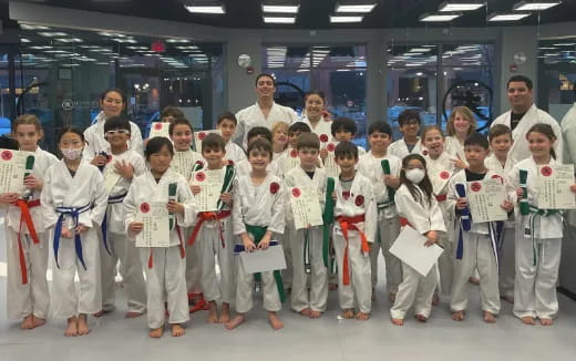 a group of children in white karate uniforms