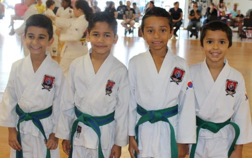 a group of girls in karate uniforms
