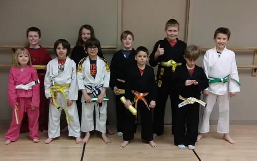 a group of children in karate uniforms