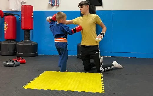 a person and a boy in a gym