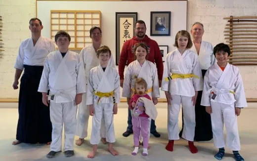 a group of people in white karate uniforms