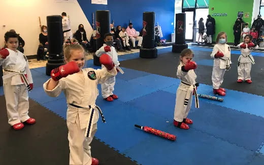a group of children in white karate uniforms
