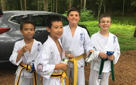 a group of boys in karate uniforms