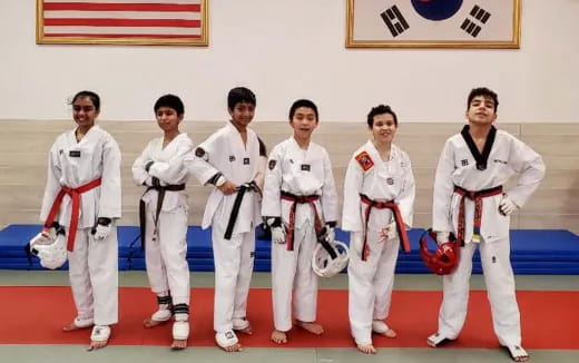 a group of people in karate uniforms